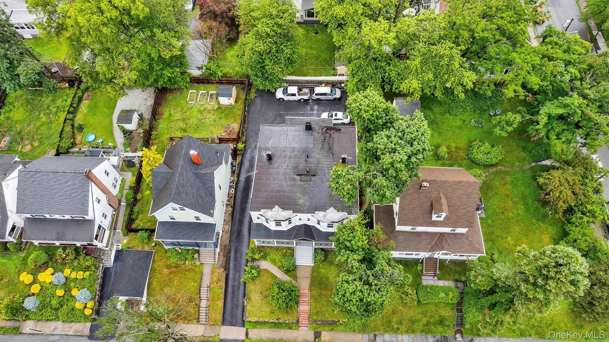 357 Dyckman Street Peekskill, NY 10566 - Photo 6 of 48 an aerial view of a house with a garden and trees