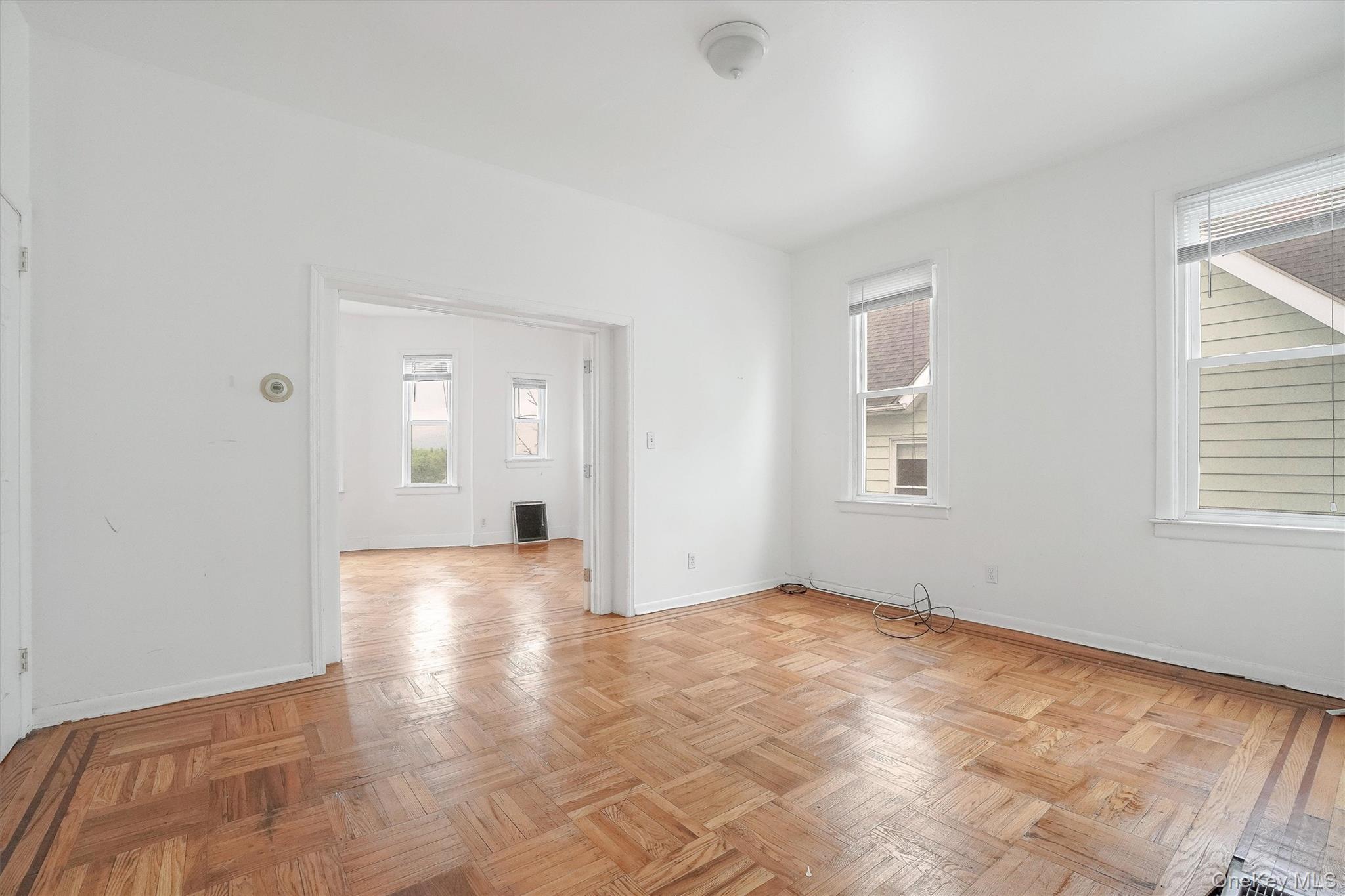 357 Dyckman Street Peekskill, NY 10566 - Photo 10 of 48 wooden floor in an empty room with a window