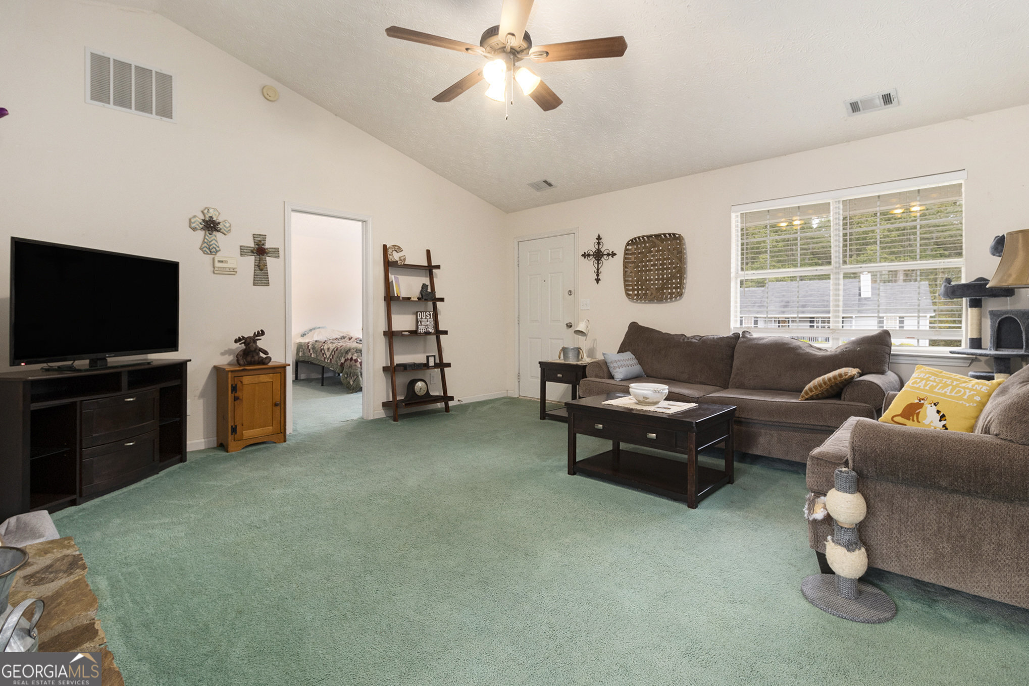 248 Fern Court Hampton, GA 30228 - Photo 9 of 20 a living room with furniture and a flat screen tv