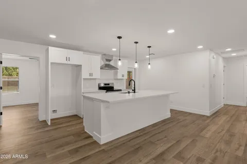 a kitchen with a sink and chandelier