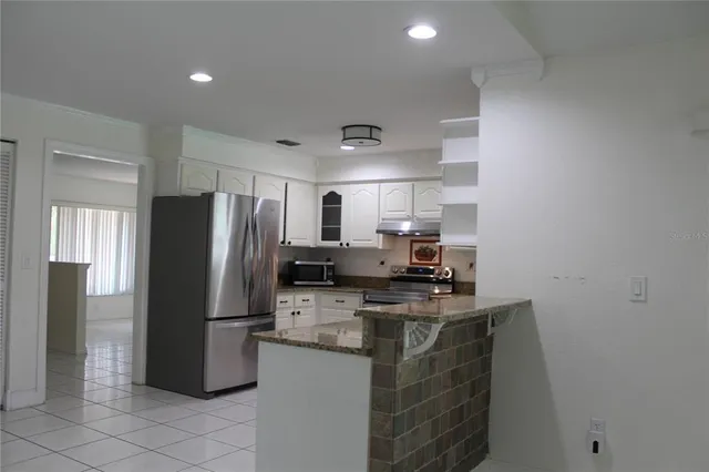a kitchen with stainless steel appliances a refrigerator sink and stove