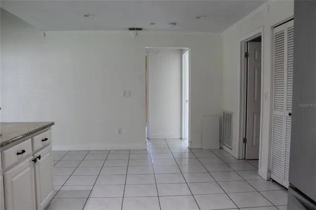 a view of an empty room with closet