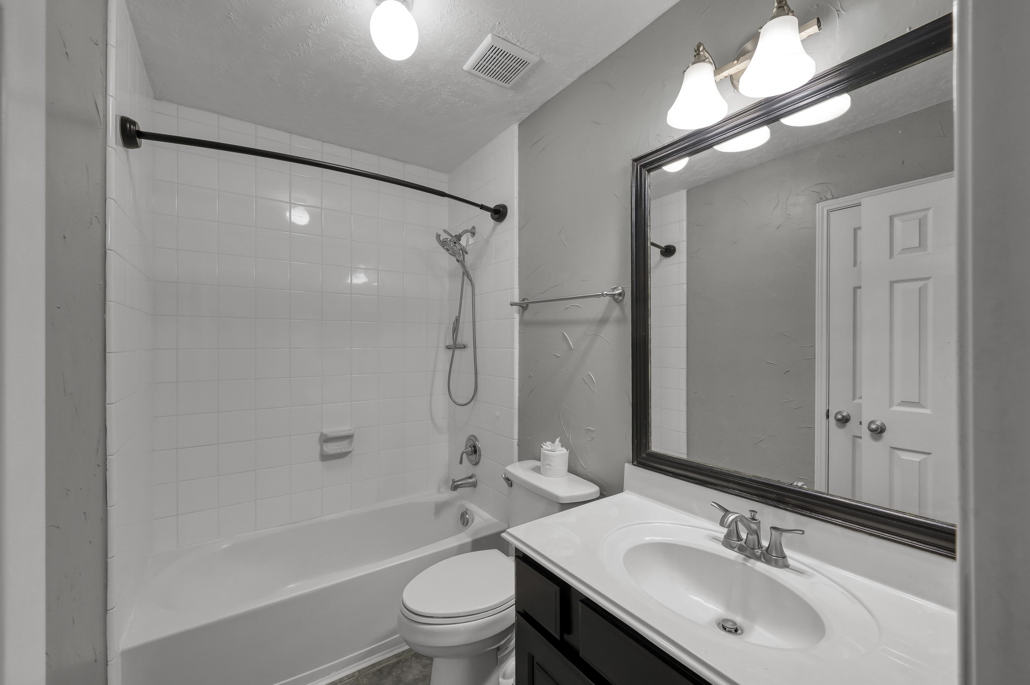 21331 Timber Pines Drive Spring, TX 77388 - Photo 17 of 22 A full-sized bathroom features vanity cabinet for storage and a shower/tub combination with tile surround!