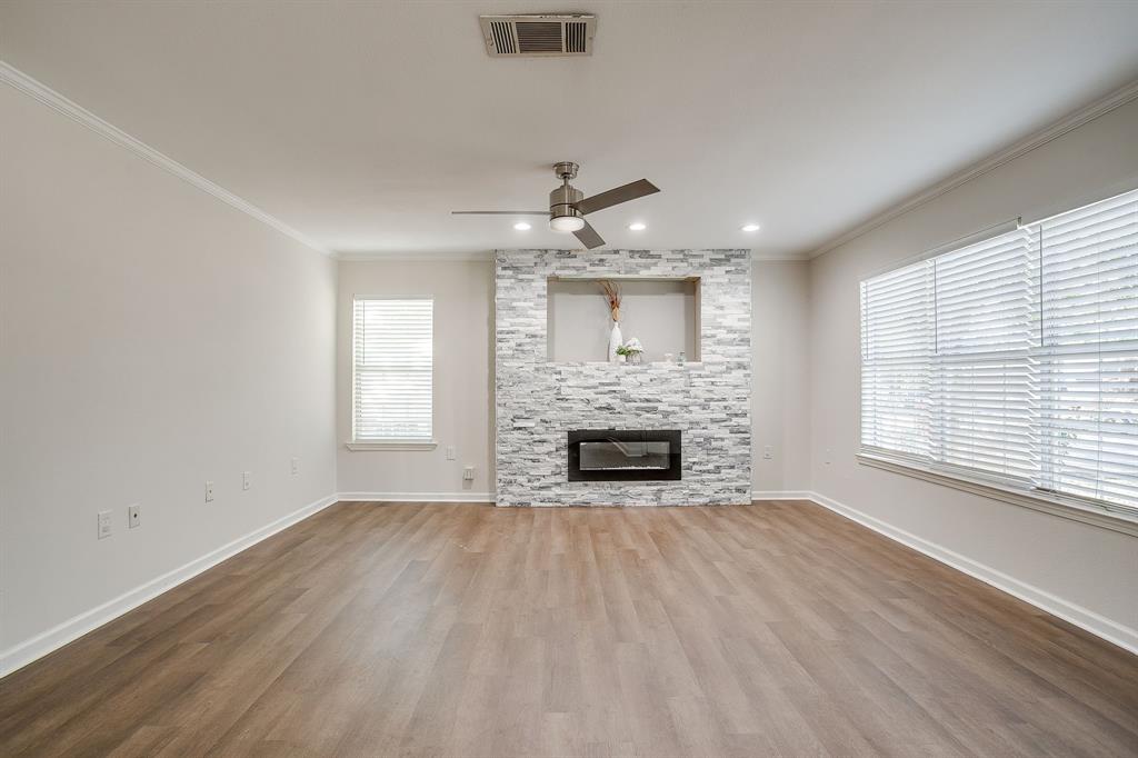 2725 Halbert Street Fort Worth, TX 76112 - Photo 1 of 15 Living room with ornamental molding, a fireplace, a ceiling fan, wood finished floors, and healthy amount of natural light