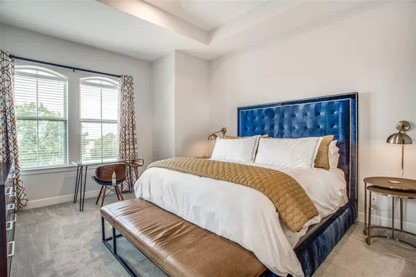 a bed sitting in a bedroom next to a window