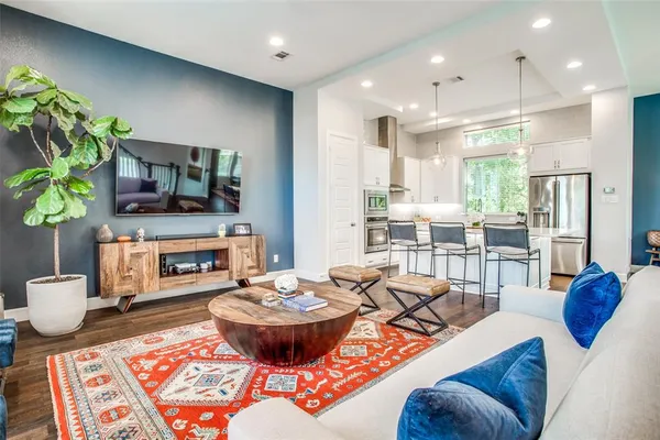 a living room with fireplace furniture and a wooden floor