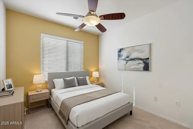 a bedroom with a bed and a chandelier