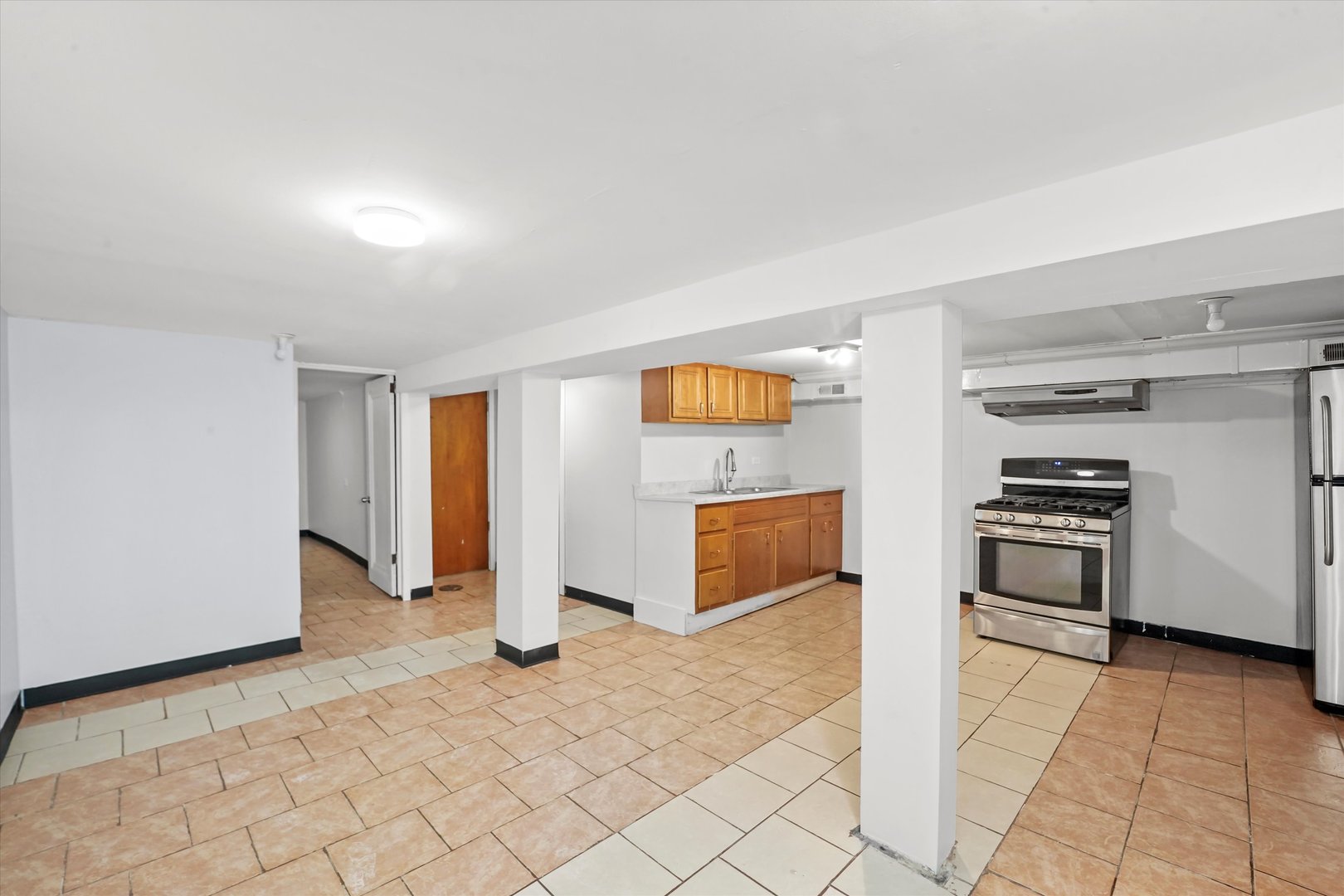 2713 West 24th Place Chicago, IL 60608 - Photo 11 of 31 a view of a kitchen with furniture and an empty room