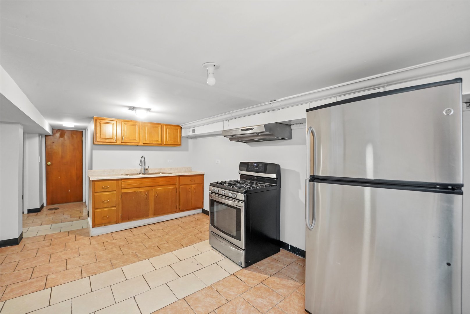 2713 West 24th Place Chicago, IL 60608 - Photo 12 of 31 a kitchen with a refrigerator sink and stove