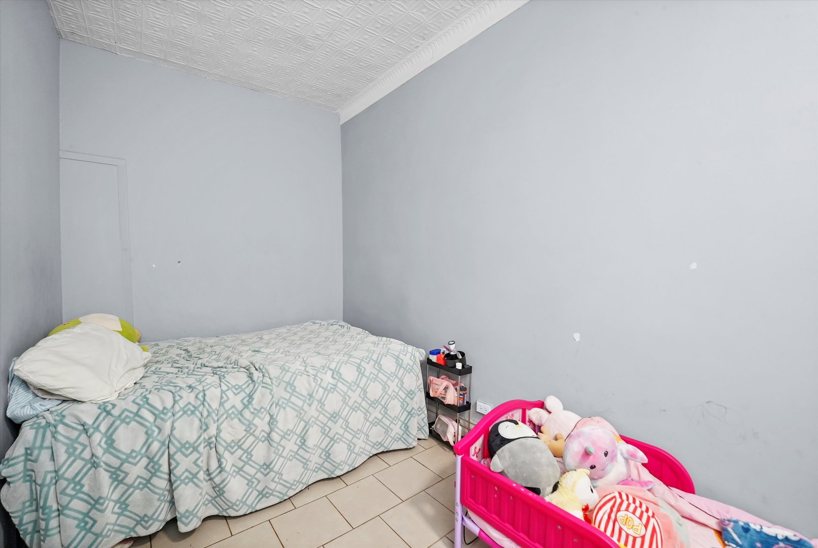 2713 West 24th Place Chicago, IL 60608 - Photo 16 of 31 a bedroom with a bed and a window