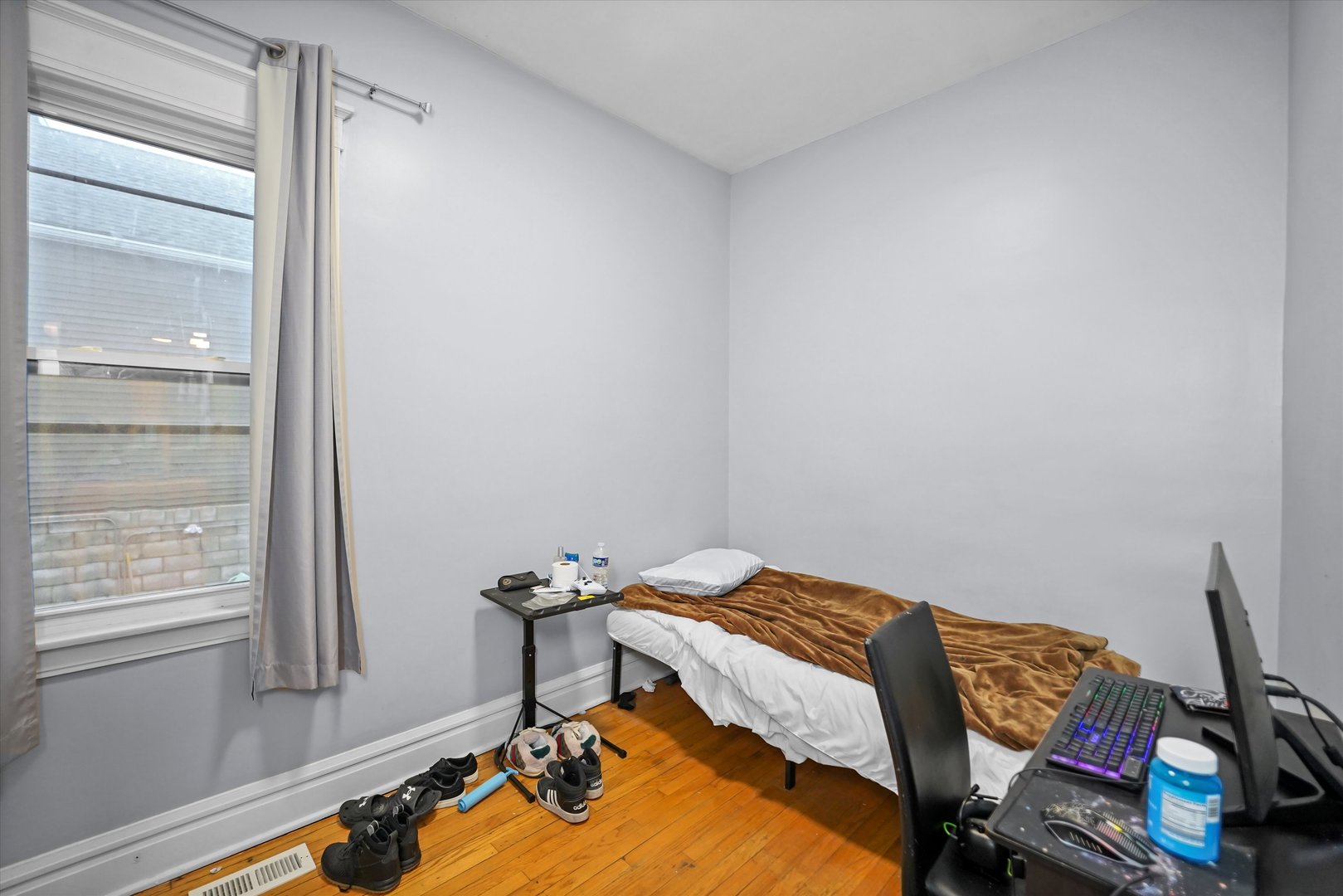 2713 West 24th Place Chicago, IL 60608 - Photo 5 of 31 a bedroom with a bed and a window