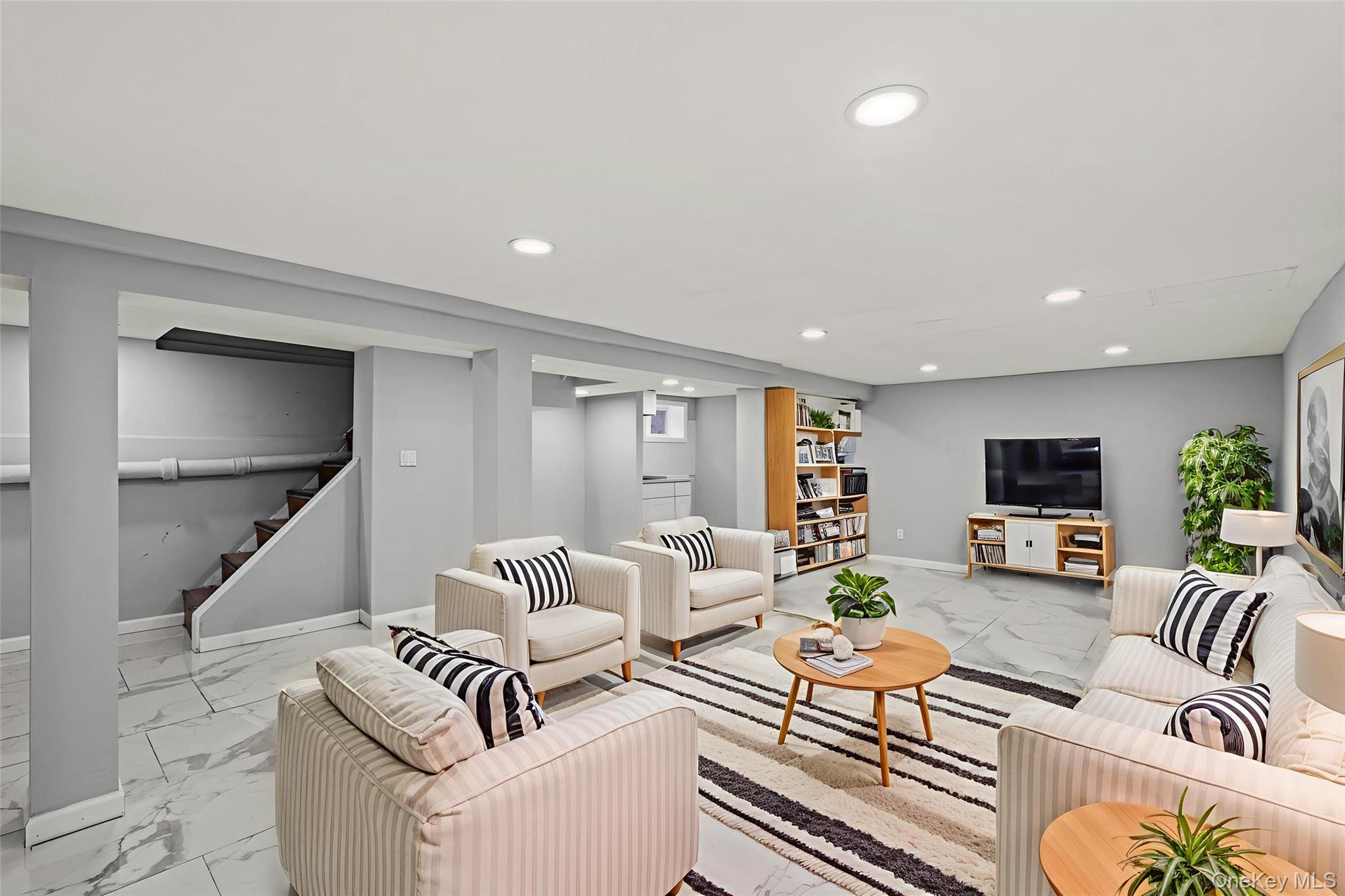 28 Cornwall Lane Hempstead, NY 11550 - Photo 12 of 20 a living room with furniture and a flat screen tv
