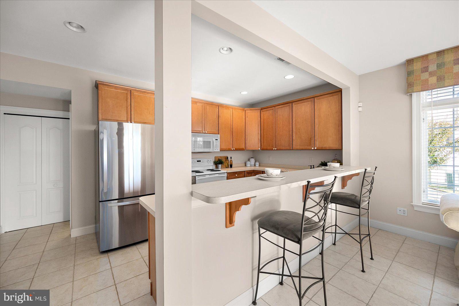 12901 Old Bridge Road, Unit PH8 2 Ocean City, MD 21842 - Photo 43 of 79 a kitchen with stainless steel appliances granite countertop a refrigerator and a stove top oven