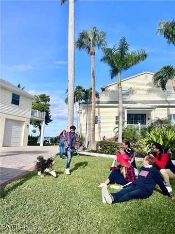 a front view of a house with a garden and patio
