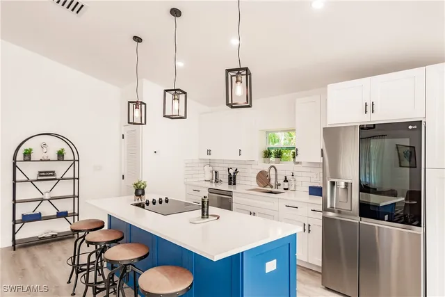 a living room with furniture a chandelier and a dining table