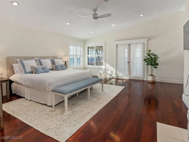 a spacious bathroom with a granite countertop double vanity sink a mirror and shower
