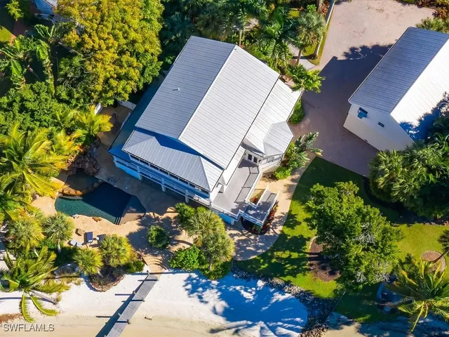 a view of a house with a yard and sitting area