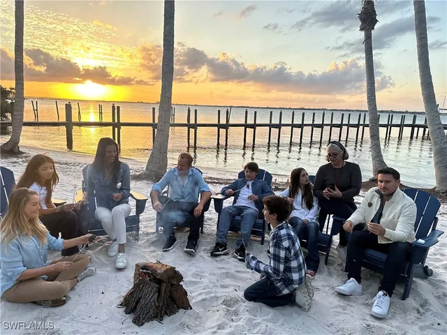 a living room with furniture and floor to ceiling window