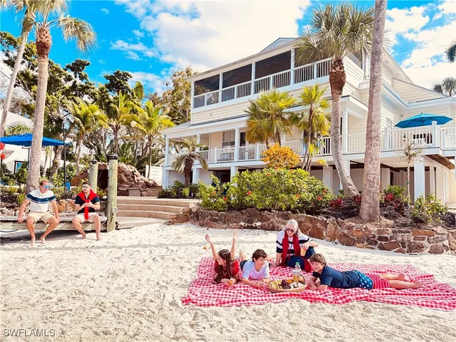 a front view of a multi story residential apartment building with yard