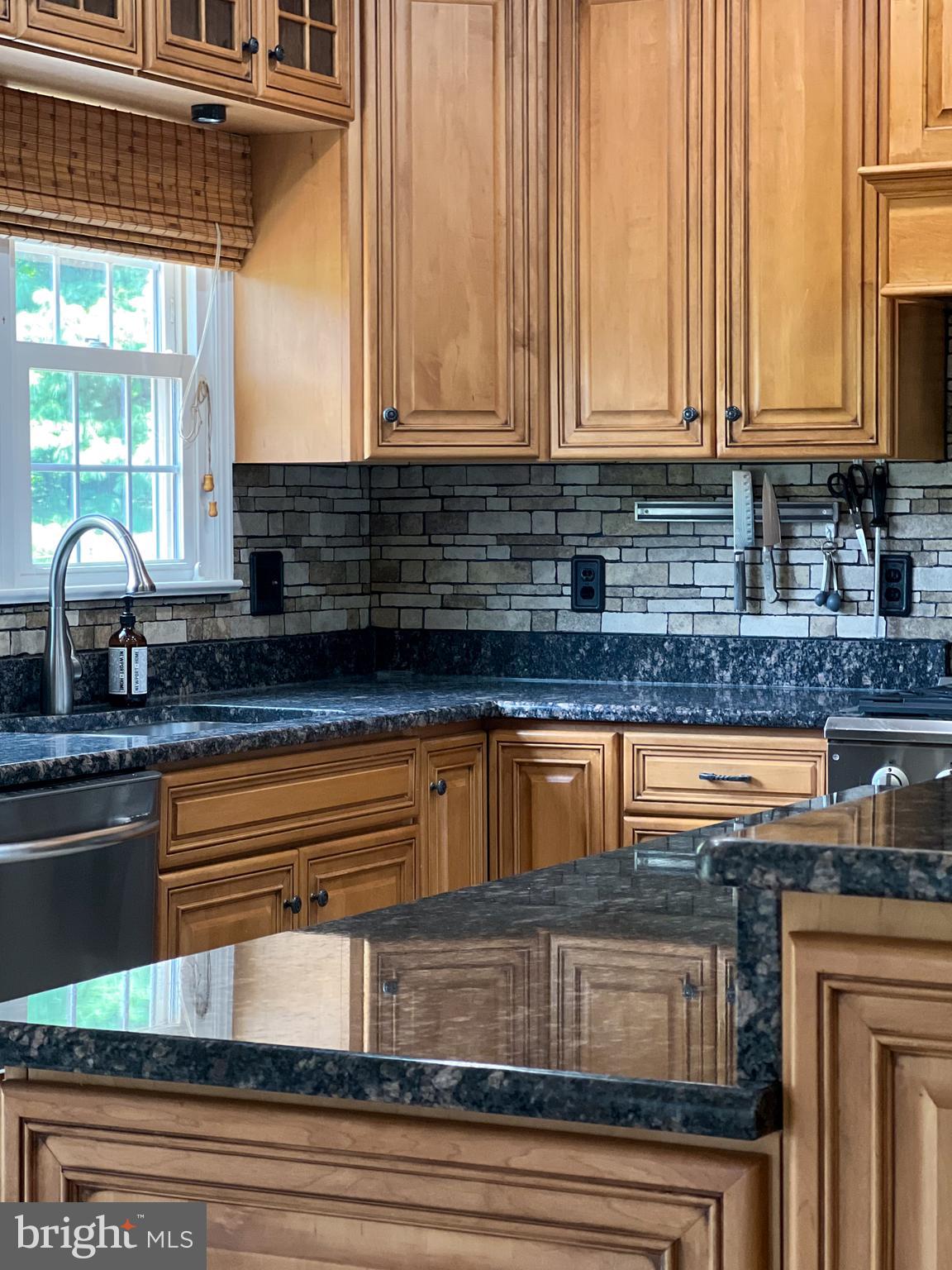 43232 Wayside Circle Ashburn, VA 20147 - Photo 42 of 105 a kitchen with stainless steel appliances granite countertop a coffee maker on granite counter tops and a white cabinets