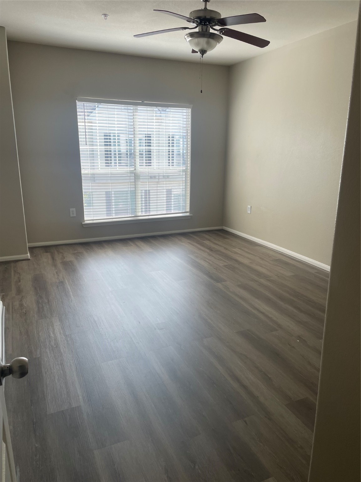 9200 Westheimer Road, Unit 1308 Houston, TX 77063 - Photo 1 of 12 an empty room with wooden floor fan and windows