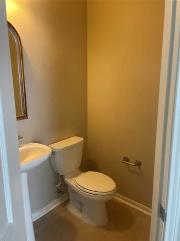 a white toilet sitting next to a small bathroom