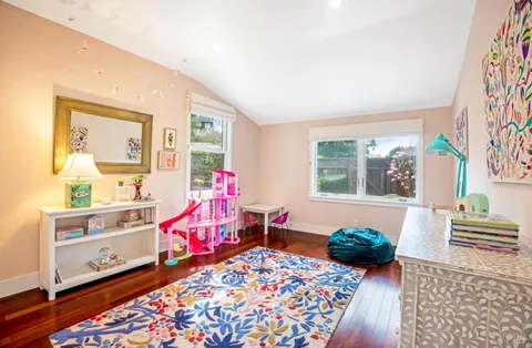 a spacious bedroom with a bed and a view of kitchen