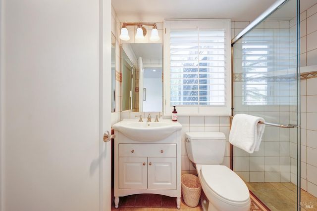 a view of a balcony with wooden chairs and a table
