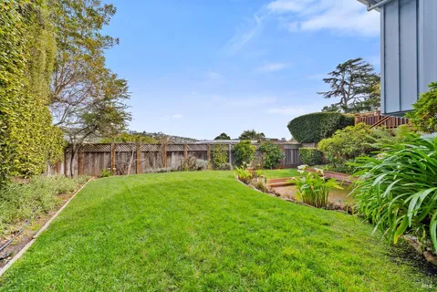 a backyard of a house with outdoor seating