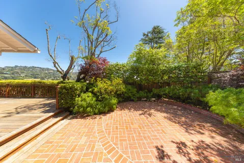 a aerial view of a house next to a yard