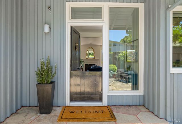 a living room with fireplace furniture and a large window