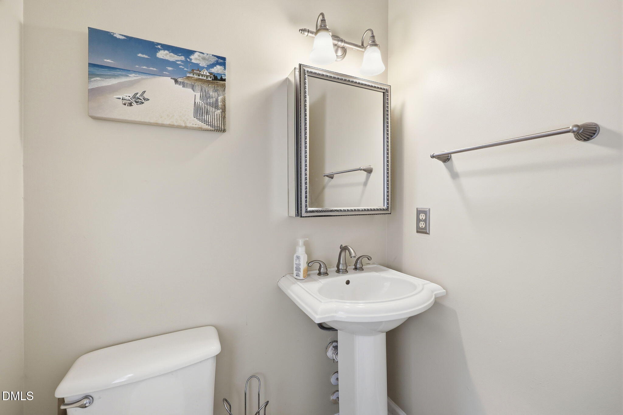 9105 Willow Valley Court Raleigh, NC 27617 - Photo 17 of 51 a bathroom with a toilet sink and mirror