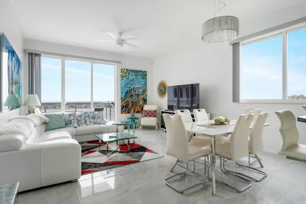a living room with furniture and a chandelier