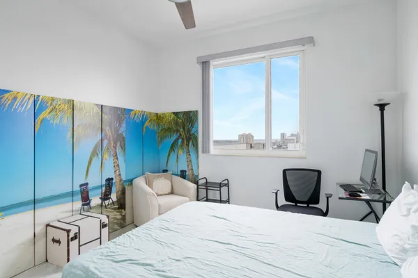 a bedroom with furniture and a large window