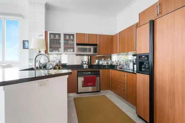 a kitchen with stainless steel appliances granite countertop a stove a sink and a refrigerator