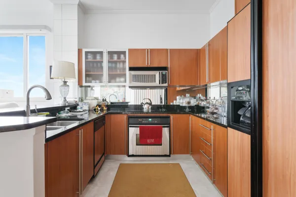 a kitchen with stainless steel appliances granite countertop a stove sink and cabinets