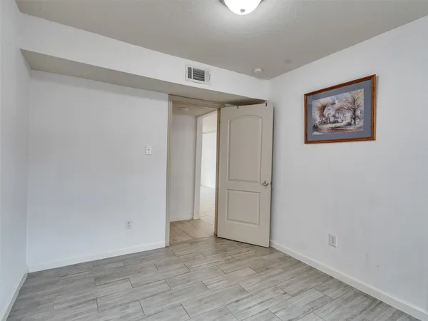 an empty room with wooden floor