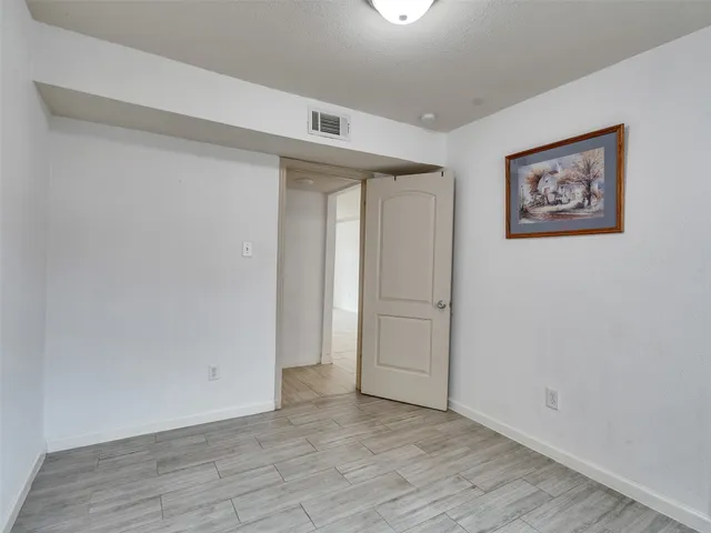 an empty room with wooden floor