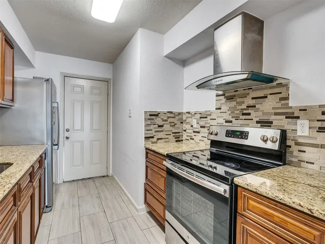 a kitchen with a stove and a sink