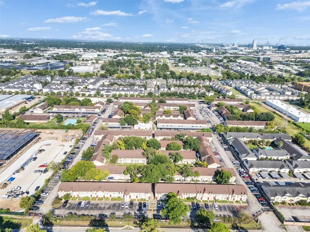an aerial view of residential building with green space