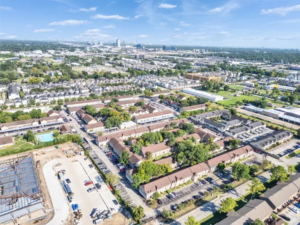 an aerial view of residential houses with city view