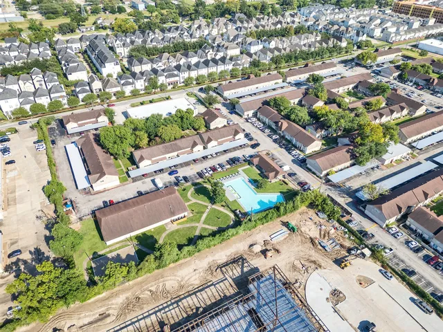 an aerial view of a house with a garden and lake view