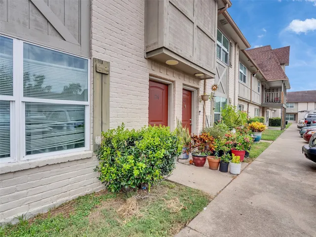 a view of a house with potted plants