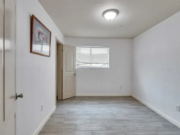 an empty room with windows and closet