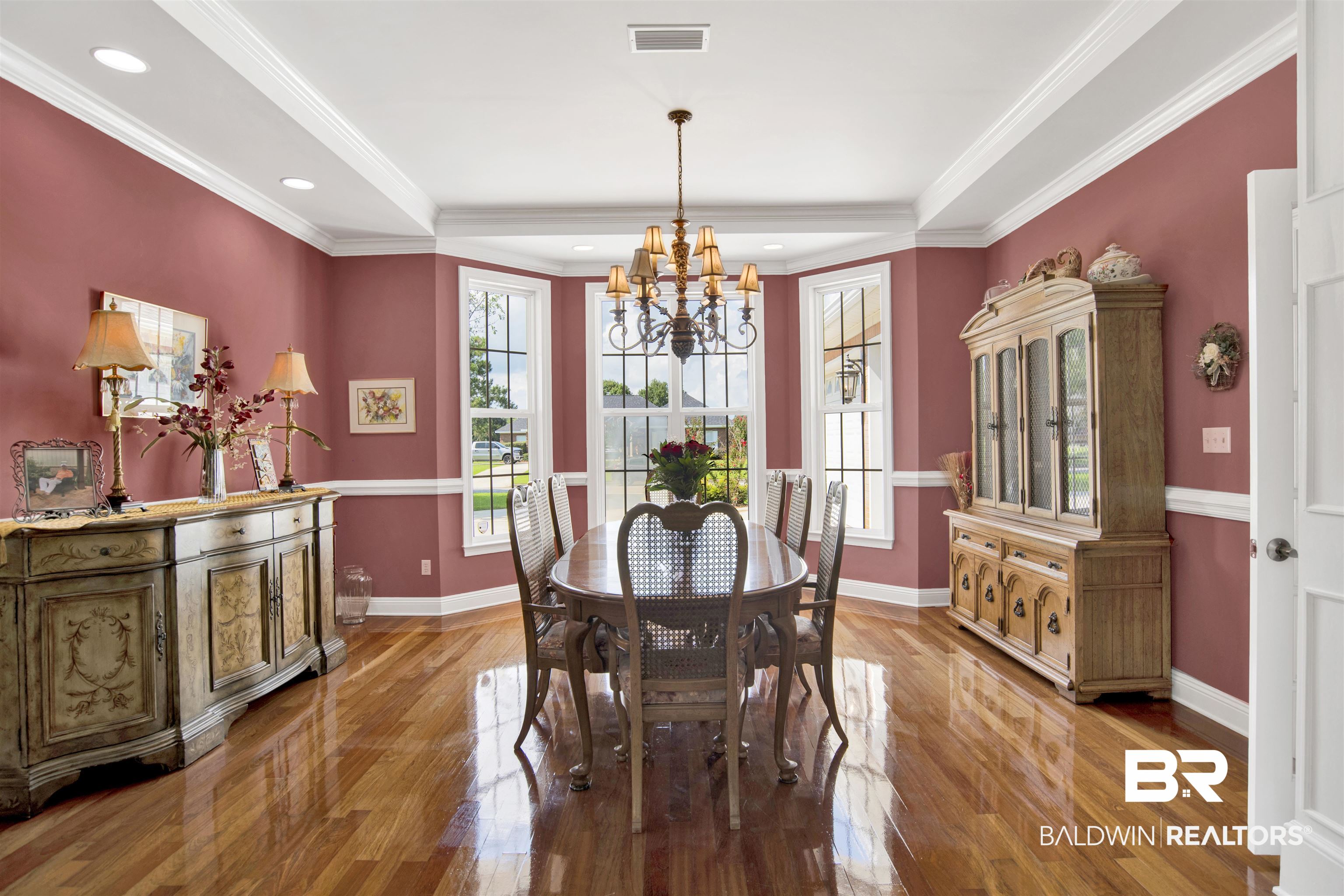 23014 Carnoustie Drive Foley, AL 36535 - Photo 19 of 49 Dining room featuring crown molding, light wood-style flooring, a chandelier, recessed lighting, and a raised ceiling