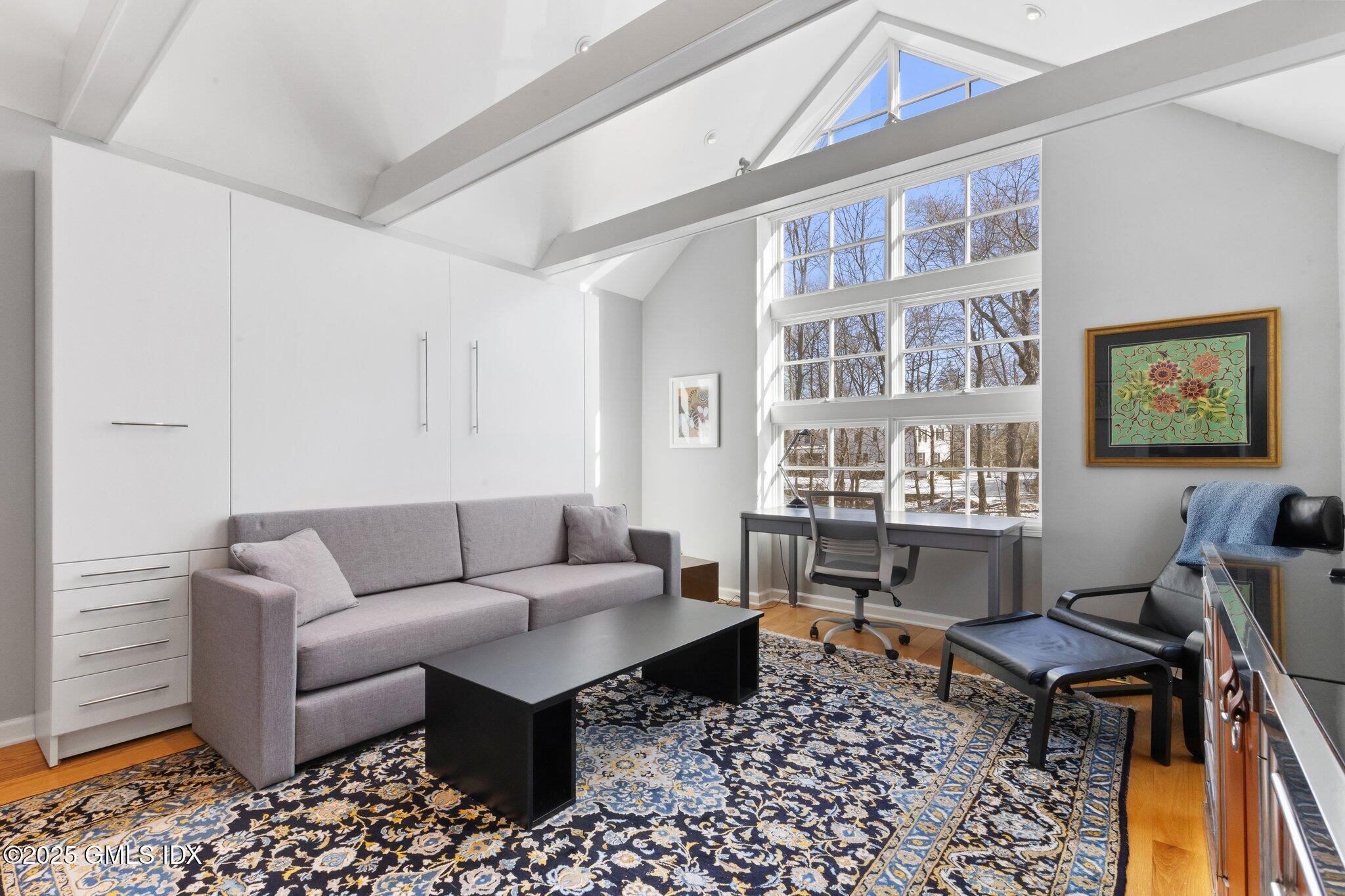 84 Indian Harbor Drive Greenwich, CT 06830 - Photo 3 of 16 a living room with furniture two windows and a table