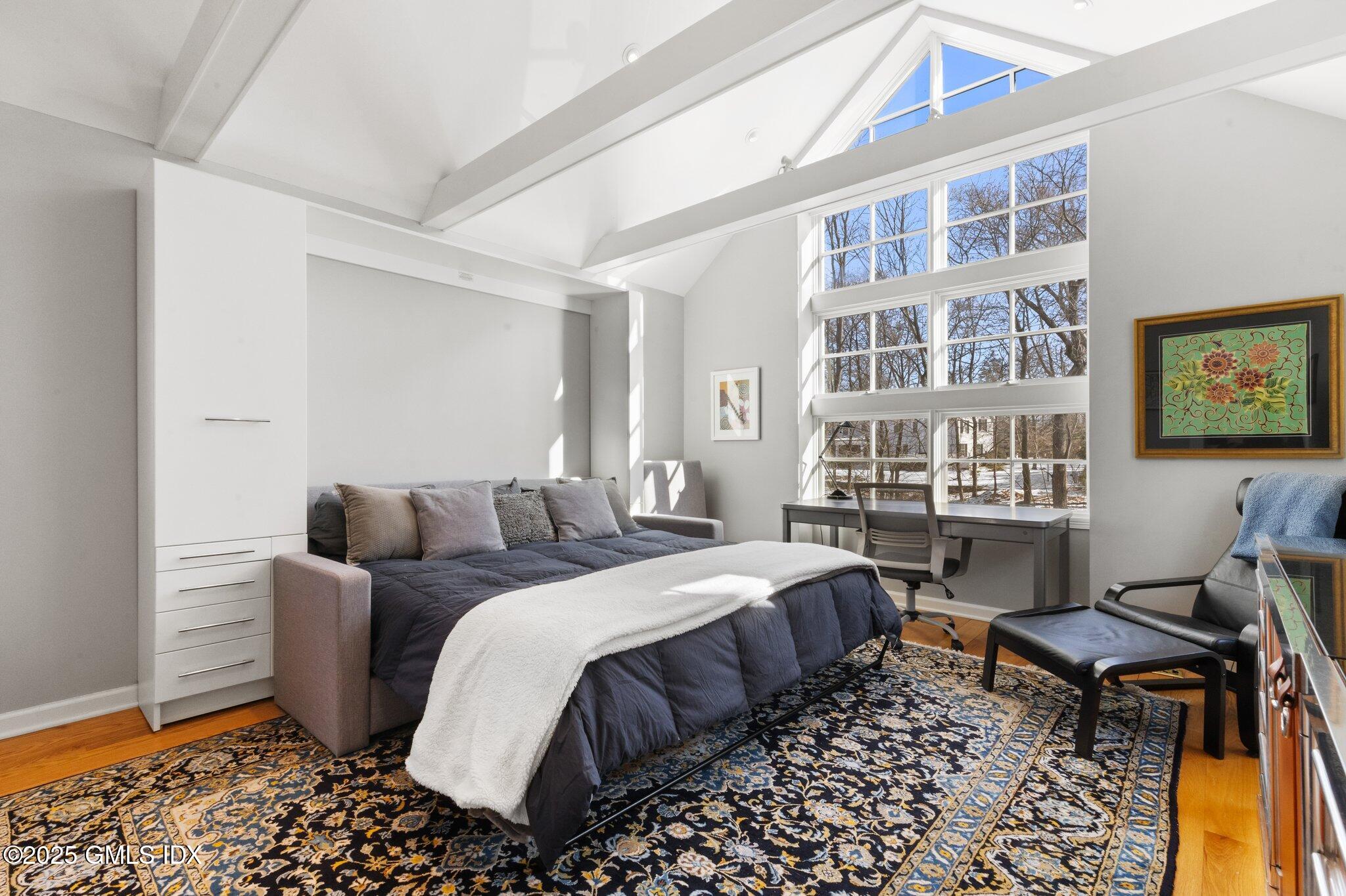 84 Indian Harbor Drive Greenwich, CT 06830 - Photo 4 of 16 a bed room with a bed and a chair