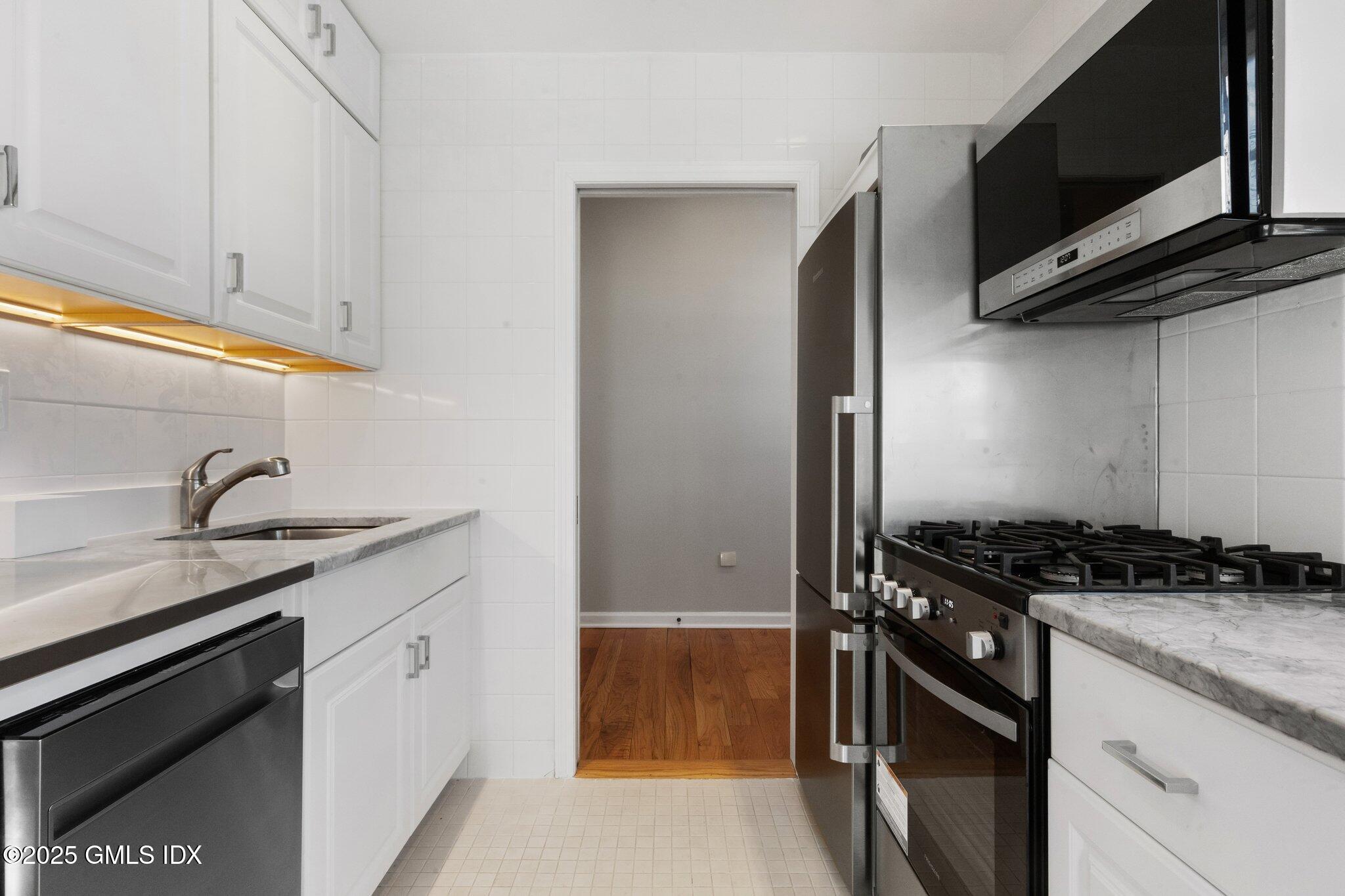 84 Indian Harbor Drive Greenwich, CT 06830 - Photo 6 of 16 a kitchen with stainless steel appliances granite countertop a sink and a stove