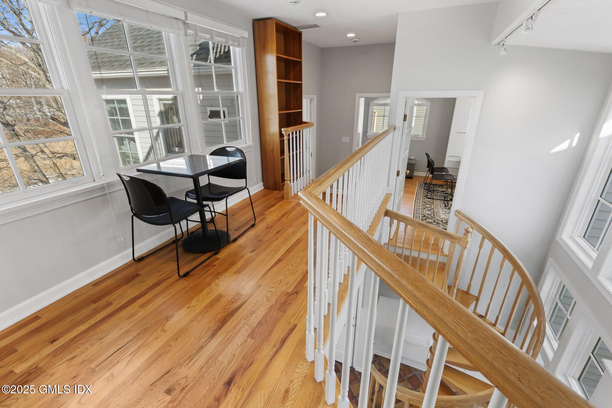 84 Indian Harbor Drive Greenwich, CT 06830 - Photo 7 of 16 a view of a livingroom with furniture stairs wooden floor and windows