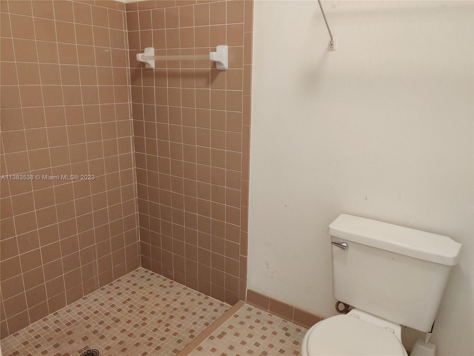 141 Arrowhead Circle Jupiter, FL 33458 - Photo 13 of 25 a bathroom with a toilet and a shower